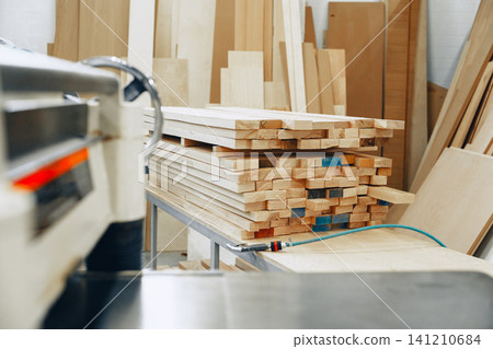 Furniture workshop showing stacks of wood ready for crafting furniture Furniture workshop showing stacks of wood ready for crafting furniture 141210684