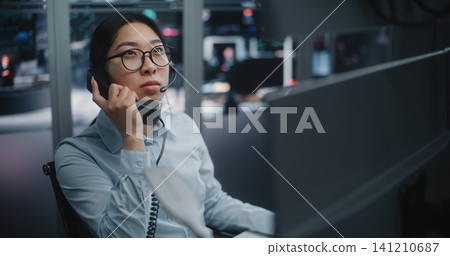Professional Stock Exchange Operator Speaks on Landline Phone Professional Stock Exchange Operator Speaks on Landline Phone 141210687