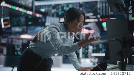 Anxious Female Stock Analyst Confronting Major Loss and Market Volatility at Workstation Anxious Female Stock Analyst Confronting Major Loss and Market Volatility at Workstation 141210712