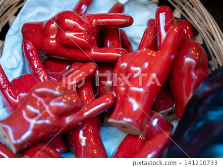 Naples, italy. December 28, 2024. Traditional small red ceramic cornicello good luck charms for sale in san gregorio armeno street in naples, italy Naples, italy. December 28, 2024. Traditional small red ceramic cornicello good luck charms for sale in san gregorio armeno street in naples, italy 141210733
