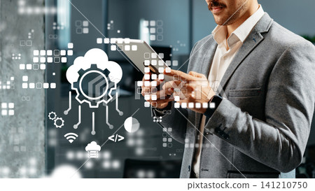 Business professional uses tablet in office to manage ERP SaaS CRM solutions Business professional uses tablet in office to manage ERP SaaS CRM solutions 141210750