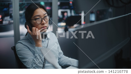 Professional Stock Exchange Operator Speaks on Landline Phone Professional Stock Exchange Operator Speaks on Landline Phone 141210778