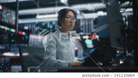 Female Trader Analyzing Real Time Stock Market Data at Large Screens Female Trader Analyzing Real Time Stock Market Data at Large Screens 141210864