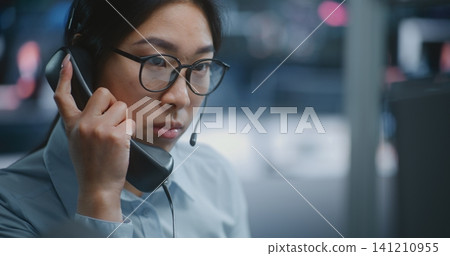 Female Stock Exchange Trader Manages Live Market Operations While Speaking on Landline Phone Female Stock Exchange Trader Manages Live Market Operations While Speaking on Landline Phone 141210955