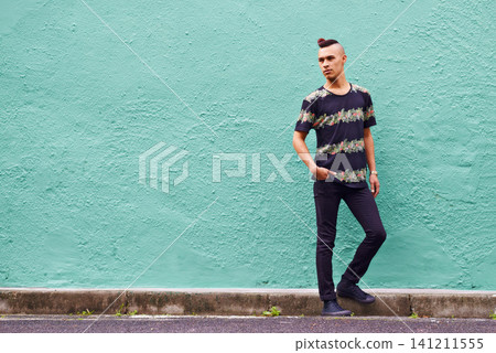Man, confidence and serious outdoors for fashion, weekend and casual style for hipster trend. Male person, travel and mockup space by wall background, aesthetic and streetwear or clothes for attitude Man, confidence and serious outdoors for fashion, weekend and casual style for hipster trend. Male person, travel and mockup space by wall background, aesthetic and streetwear or clothes for attitude 141211555