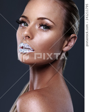 Beauty, portrait and woman with crystal on lips in studio with jewelry isolated on black background. Diamond, face and serious model with creative makeup for skincare, cosmetics or art for aesthetic Beauty, portrait and woman with crystal on lips in studio with jewelry isolated on black background. Diamond, face and serious model with creative makeup for skincare, cosmetics or art for aesthetic 141211795