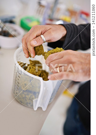 Beer manufacturing, hops or barley in hands and cup for process, factory or brewery with tools for drink. Person measuring natural ingredients, alcohol production in lab or distillery in industry Beer manufacturing, hops or barley in hands and cup for process, factory or brewery with tools for drink. Person measuring natural ingredients, alcohol production in lab or distillery in industry 141211860