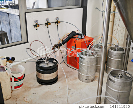 Factory, craft beer and alcohol with barrel for production, manufacturing and pipes in workshop. Warehouse, plant or industry with metal tube, steel and machine for lager, stout or valve in container Factory, craft beer and alcohol with barrel for production, manufacturing and pipes in workshop. Warehouse, plant or industry with metal tube, steel and machine for lager, stout or valve in container 141211930