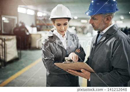 Man, woman and checklist with clipboard in factory for quality inspection or safety checks and process monitoring. Team, communication and board for manufacturing information in printing warehouse. Man, woman and checklist with clipboard in factory for quality inspection or safety checks and process monitoring. Team, communication and board for manufacturing information in printing warehouse. 141212048