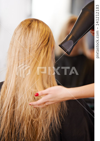 Back view, hair and hand with hairdryer for beauty, people at hairdresser for haircare, maintenance and heat treatment. Electric appliance, styling and blow drying for makeover with cosmetic care Back view, hair and hand with hairdryer for beauty, people at hairdresser for haircare, maintenance and heat treatment. Electric appliance, styling and blow drying for makeover with cosmetic care 141212183