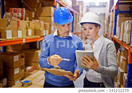 Warehouse, man and woman with tablet, teamwork and inspecting inventory with cooperation. Large distribution, supervisor and management with technology and update schedule with app and industrial Warehouse, man and woman with tablet, teamwork and inspecting inventory with cooperation. Large distribution, supervisor and management with technology and update schedule with app and industrial 141212270
