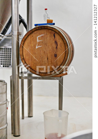Brewery equipment, barre and craft beer production in factory for natural fermentation. Manufacturing, cask and wood container for alcohol, distillery and storage for liquid at plant with cider Brewery equipment, barre and craft beer production in factory for natural fermentation. Manufacturing, cask and wood container for alcohol, distillery and storage for liquid at plant with cider 141212327