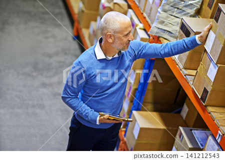 Tablet, box or above of man in warehouse for delivery order label, storage or stock in factory for website. Printing, mature manager or supply chain inspection on cargo, package or wholesale shipping Tablet, box or above of man in warehouse for delivery order label, storage or stock in factory for website. Printing, mature manager or supply chain inspection on cargo, package or wholesale shipping 141212543