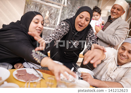 Muslim family, Eid and excited by table with food for eating, celebration and conversation together. Islamic people, culture and religious event with fight for lunch, nutrition and special holiday Muslim family, Eid and excited by table with food for eating, celebration and conversation together. Islamic people, culture and religious event with fight for lunch, nutrition and special holiday 141212623