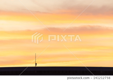 A minimalist landscape with layers of sunset sky and clouds; background material with copy space. 141212738