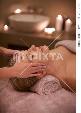 Face massage, spa and relax with woman, luxury and candle with hospitality and stress relief. Person, facial and girl with wellness or healthy with vacation or beauty with holiday, detox or self care 141212798
