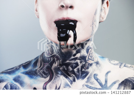 Person, ink and drip for mouth with tattoo for creative, body and design in studio, pattern and horror. Art, bold and punk for symbol on skin for paint, liquid and unique for nightmare and scary Person, ink and drip for mouth with tattoo for creative, body and design in studio, pattern and horror. Art, bold and punk for symbol on skin for paint, liquid and unique for nightmare and scary 141212887