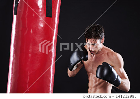 Man, punching bag and martial arts with fitness, exercise and fighter with gloves and progress with cardio. Boxer, practice or athlete with training, gym or workout with endurance, health or wellness 141212983