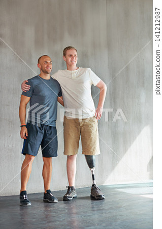 Physiotherapist, man with a disability and prosthetic leg and hug in physiotherapy, studio and gym. Male people, trainer and amputee for wellness, fitness and exercise in rehabilitation center Physiotherapist, man with a disability and prosthetic leg and hug in physiotherapy, studio and gym. Male people, trainer and amputee for wellness, fitness and exercise in rehabilitation center 141212987