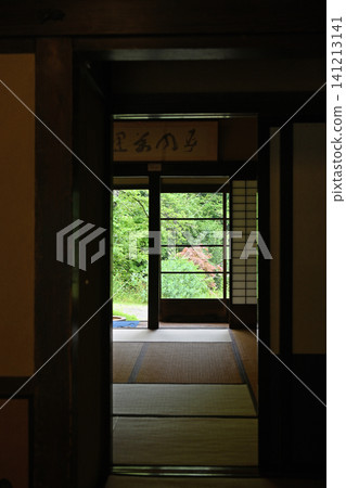 A traditional Japanese house; a lush garden and traditional beauty viewed from the dimly lit interior. A traditional Japanese house; a lush garden and traditional beauty viewed from the dimly lit interior. 141213141