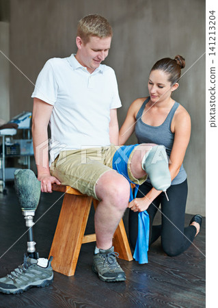 Physio, patient with disability or leg in training, fitness or workout as health, support or medical. Man, personal trainer or band in wellness, exercise or clinic as advice or care for amputee Physio, patient with disability or leg in training, fitness or workout as health, support or medical. Man, personal trainer or band in wellness, exercise or clinic as advice or care for amputee 141213204