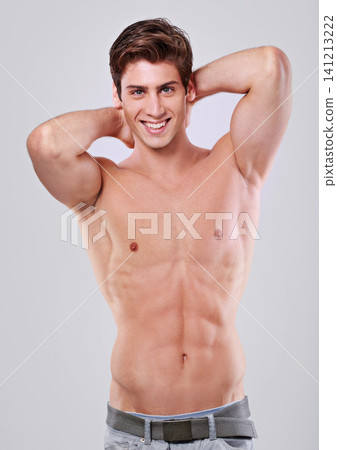 Happy man, portrait and confidence with muscular body in fitness, health or wellness on a gray studio background. Handsome, attractive or young male person or model with smile and abs in satisfaction Happy man, portrait and confidence with muscular body in fitness, health or wellness on a gray studio background. Handsome, attractive or young male person or model with smile and abs in satisfaction 141213222