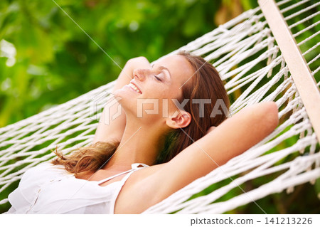 Happy woman, rest and wellness on hammock in outdoor, peace and summer vacation in sunshine in nature. Young person, smile and sleep by trees at beach resort, calm and holiday for leisure on island Happy woman, rest and wellness on hammock in outdoor, peace and summer vacation in sunshine in nature. Young person, smile and sleep by trees at beach resort, calm and holiday for leisure on island 141213226