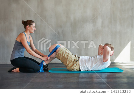 Man, woman and physiotherapy with prosthetic, amputee and leg at rehabilitation, exercise and training. Physiotherapist, patient and fitness for workout, band and routine for person with a disability 141213253