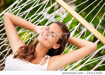 Happy woman, rest and wellness on hammock in nature, peace and vacation in summer on tropical island. Young person, smile and sleep in sun at beach resort, calm and holiday for leisure in outdoor Happy woman, rest and wellness on hammock in nature, peace and vacation in summer on tropical island. Young person, smile and sleep in sun at beach resort, calm and holiday for leisure in outdoor 141213305