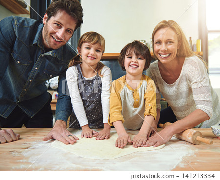 Portrait, smile and family baking pizza in kitchen together, bonding and happy for learning in home. Face, mother and father with kids cooking, teaching and help parents with flour dough at table Portrait, smile and family baking pizza in kitchen together, bonding and happy for learning in home. Face, mother and father with kids cooking, teaching and help parents with flour dough at table 141213334