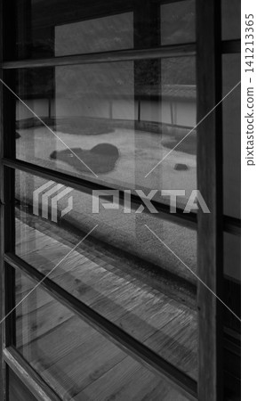 A traditional Japanese house: The dry landscape garden reflected in the glass of the lattice windows, showcasing the beauty of Japanese tradition. A traditional Japanese house: The dry landscape garden reflected in the glass of the lattice windows, showcasing the beauty of Japanese tradition. 141213365