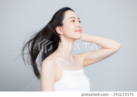 A woman blowing in the wind A woman blowing in the wind 141213375