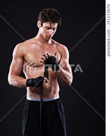 Wrapping, hands and man in martial arts for boxing on black background in studio with preparation. Tape, fist and ready to start training as boxer in mma competition or gym with fitness mockup space 141213679