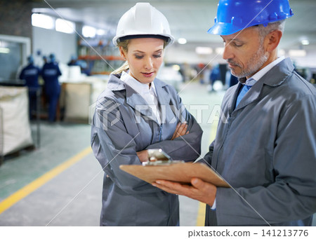 Man, woman and discussion with clipboard in factory for quality inspection or safety checks and process monitoring. Team, communication and board for manufacturing information in printing warehouse. Man, woman and discussion with clipboard in factory for quality inspection or safety checks and process monitoring. Team, communication and board for manufacturing information in printing warehouse. 141213776