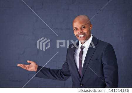 Happy, portrait and black man with presentation for advertising, show or speech on a gray studio background. African male person, businessman or young speaker with smile for marketing on mockup space Happy, portrait and black man with presentation for advertising, show or speech on a gray studio background. African male person, businessman or young speaker with smile for marketing on mockup space 141214186
