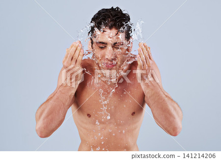 Water splash, washing face and man on blue background for skincare, wellness and cleaning in studio. Dermatology, bathroom and person with liquid and shower for hygiene, grooming and hydration Water splash, washing face and man on blue background for skincare, wellness and cleaning in studio. Dermatology, bathroom and person with liquid and shower for hygiene, grooming and hydration 141214206