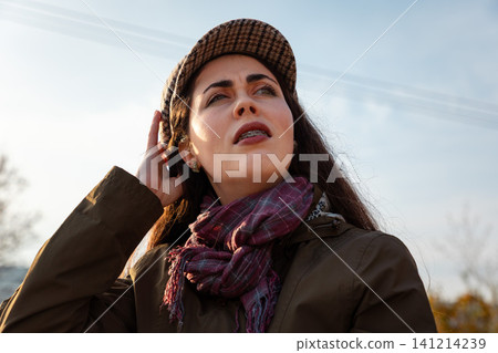 Woman touching temple with confused look Woman touching temple with confused look 141214239