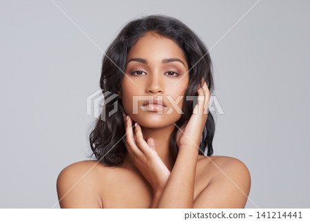 Cosmetic, health and portrait of woman in studio with skincare, wellness and natural facial routine. Serious, beauty and face of female person with dermatology treatment isolated by gray background. Cosmetic, health and portrait of woman in studio with skincare, wellness and natural facial routine. Serious, beauty and face of female person with dermatology treatment isolated by gray background. 141214441