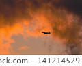 An airplane taking off into the sunset sky An airplane taking off into the sunset sky 141214529