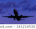 An airplane landing with the moon in the background. An airplane landing with the moon in the background. 141214530