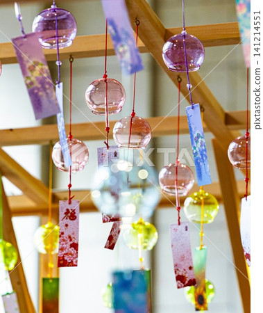 A vibrant summer scene with a row of colorful glass wind chimes. A vibrant summer scene with a row of colorful glass wind chimes. 141214551