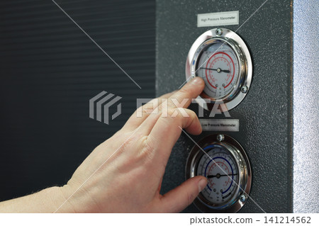 operator checking pressure in industrial equipment operator checking pressure in industrial equipment 141214562