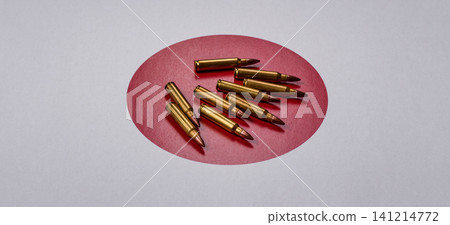 Assault rifle cartridges on the Japanese flag, serving as a conceptual backdrop for defense 141214772
