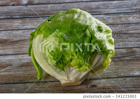 Fresh green lettuce head on rustic wooden surface Fresh green lettuce head on rustic wooden surface 141215001