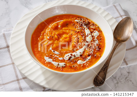 spiced sweet potato soup in a white bowl spiced sweet potato soup in a white bowl 141215347