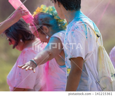 People celebrating holi festival throwing colorful powder People celebrating holi festival throwing colorful powder 141215361