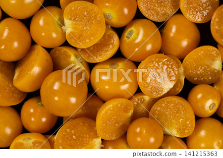 Top view background pattern of ripe physalis berries cut in half Top view background pattern of ripe physalis berries cut in half 141215363