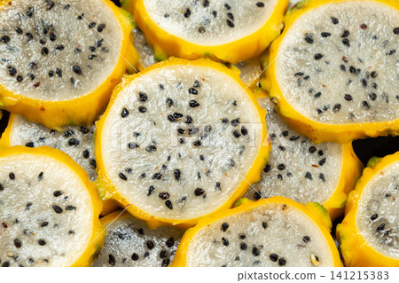 Slices of yellow dragon fruit texture background top view Slices of yellow dragon fruit texture background top view 141215383