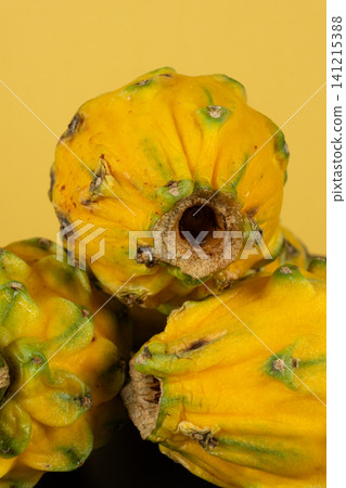 Group of whole raw exotic yellow pitahaya dragonfruits 141215388