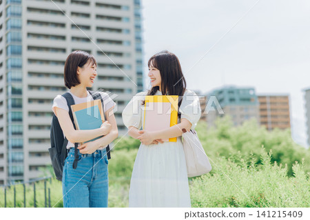 Two female university students walking on campus Two female university students walking on campus 141215409